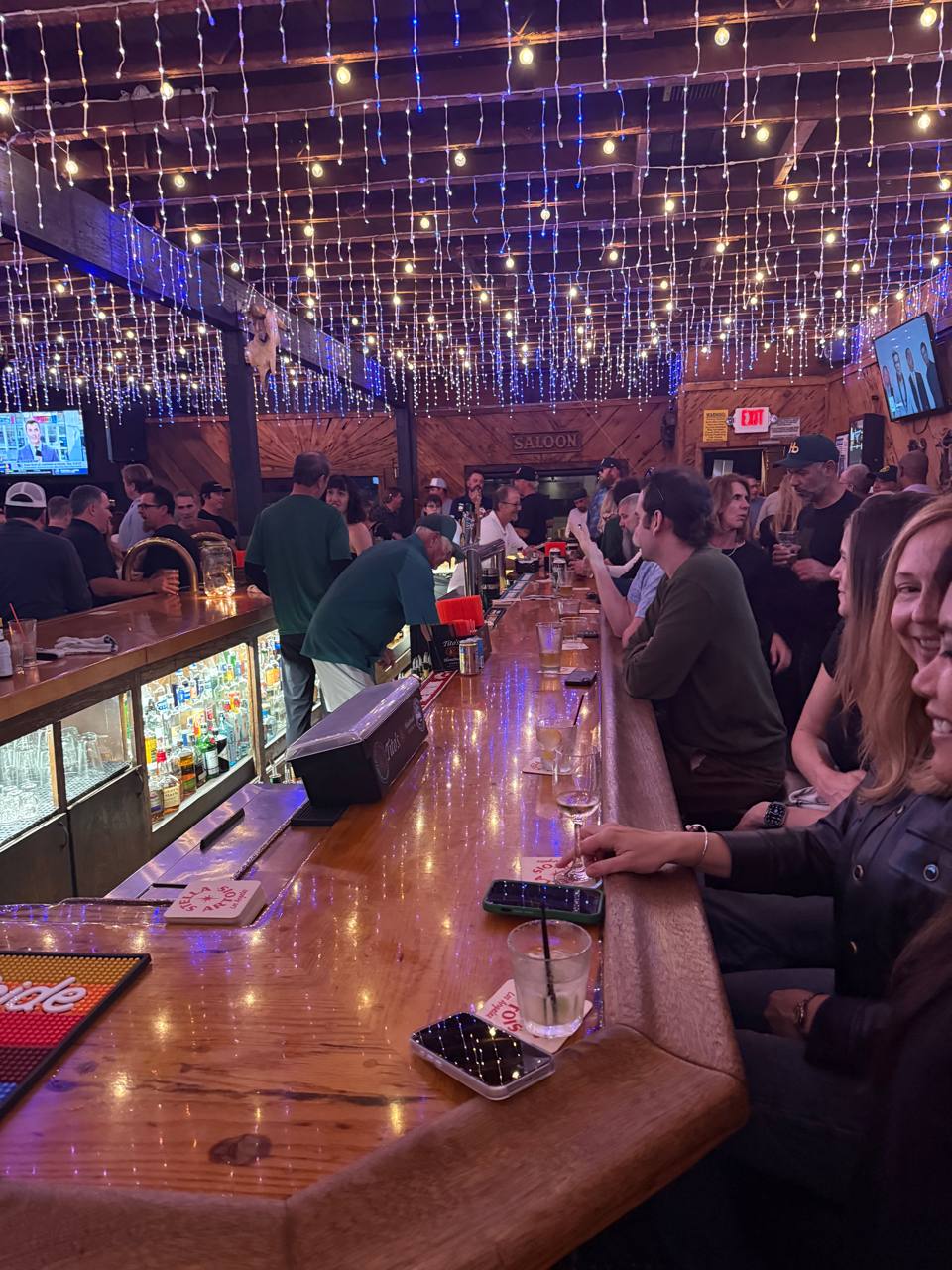 A lively group night around the bar at The Hermosa Saloon